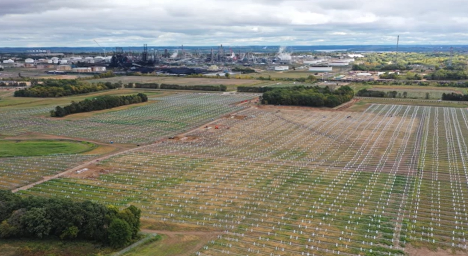 An open green field near Pine Bend refinery