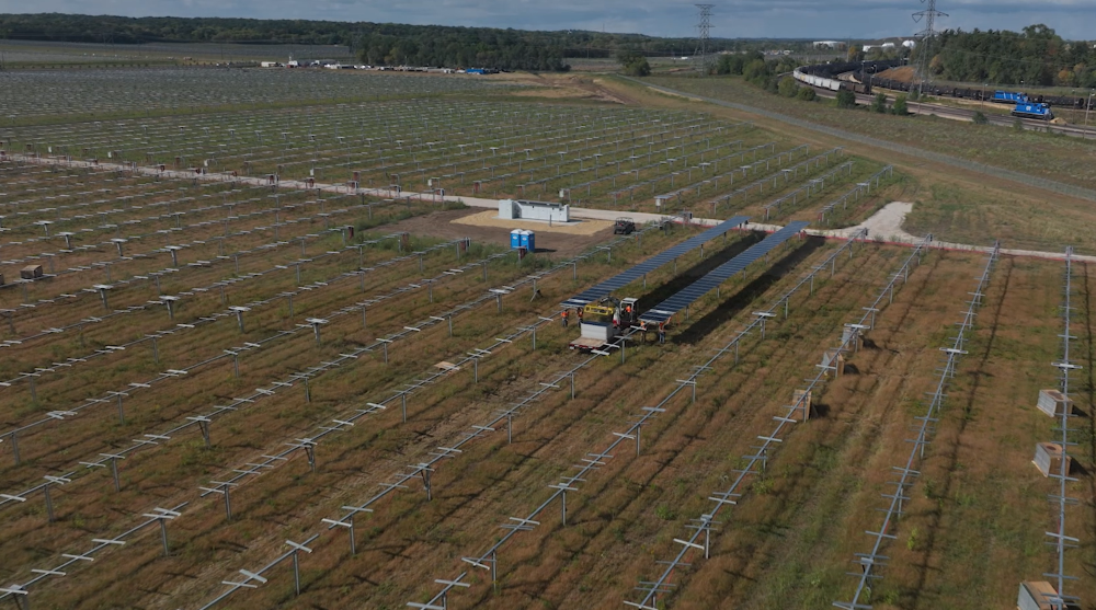 A field near Pine Bend refinery where trucks and workers lay solar panels